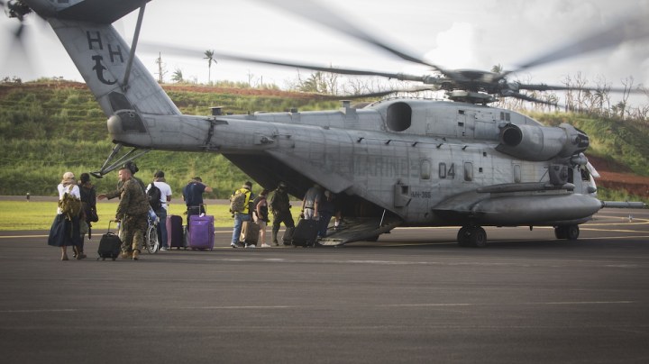 In this handout image provided by the U.S.Navy,  U.S. citizens board a U.S. Marine Corps CH-53E Super Stallion helicopter. Photo by   Ian Leonesz/US Marine Corps via Getty Images News