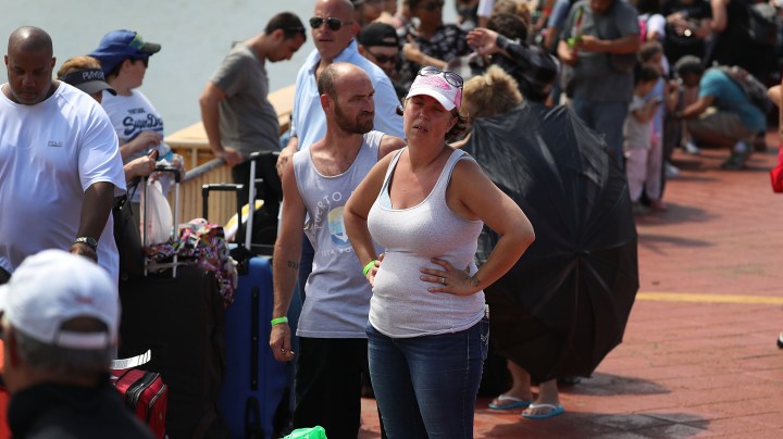 Gary Flores and Tabatha Flores stand in line with other people to get on a Royal Caribbean International, Adventure of the Seas, relief boat that is sailing to Ft. Lauderdale, Florida with evacuees that are fleeing after the island was hit by Hurricane Maria Photo by Joe Raedle/Getty Images News
