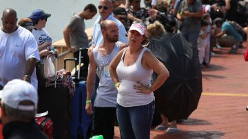 Gary Flores and Tabatha Flores stand in line with other people to get on a Royal Caribbean International, Adventure of the Seas, relief boat that is sailing to Ft. Lauderdale, Florida with evacuees that are fleeing after the island was hit by Hurricane Maria Photo by Joe Raedle/Getty Images News