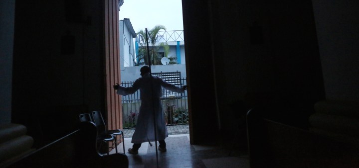 A clergyman closes the doors of the town church after evening Mass three weeks after Hurricane Maria hit the island, on October 11, 2017 in Aibonito, Puerto Rico. The evening mass is now held before sunset due to a lack of electricity. Photo by Mario Tama/Getty Images News