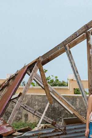 Lidybel Águila and Anabelle pose in front of the remains of their of a wooden house that used to have their favorite mural in the town of Arecibo. Photo by Stephanie Segarra for Remezcla