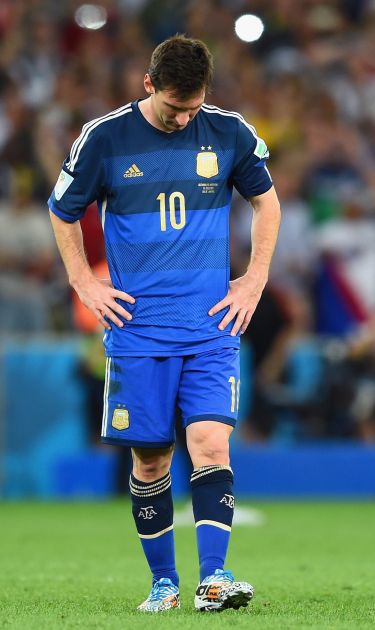A dejected Lionel Messi reacts after being defeated by Germany 1-0 in extra time during the 2014 FIFA World Cup Brazil Final. Photo by Matthias Hangst/Getty Images
