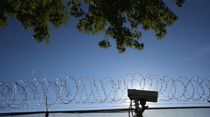 Concertina wire and a security camera line the perimiter of the York County Dentention Center. Photo by John Moore/Getty Images