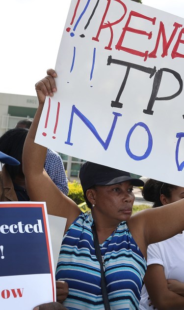 People protest the possibility that the Trump administration may overturn the Temporary Protected Status for Haitians in front of the U.S. Citizenship and Immigration Services office. Photo by Joe Raedle/Getty Images News