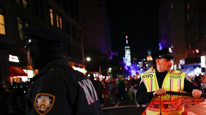 NYPD officers stand guard during the annual Halloween parade after a man driving a rental truck struck and killed eight people on a jogging and bike path in Lower Manhattan. Photo by Kena Betancur/Getty Images News