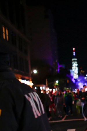 NYPD officers stand guard during the annual Halloween parade after a man driving a rental truck struck and killed eight people on a jogging and bike path in Lower Manhattan. Photo by Kena Betancur/Getty Images News