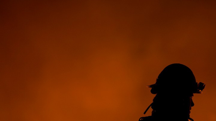 Firefighters use drip torches to set a backfire at night in an effort to make progress against the Thomas Fire before the winds return with the daylight near Lake Casitas. Photo by David McNew/Getty Images News