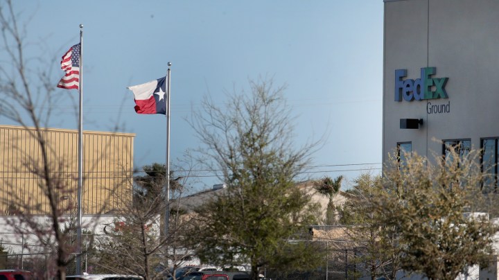 Flags fly outside a FedEx facility following an explosion on March 20, 2018 in Schertz, Texas. Photo by Scott Olson/Getty Images
