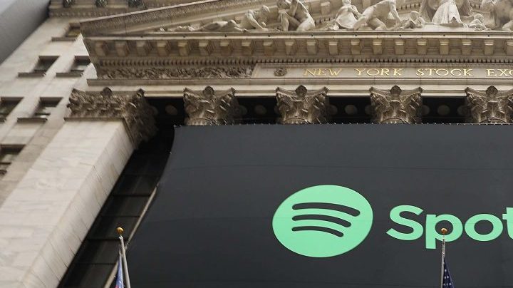 The Spotify banner hangs from the New York Stock Exchange (NYSE) on the morning that the music streaming service begins trading shares. Photo by Spencer Platt/Getty Images