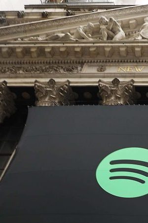 The Spotify banner hangs from the New York Stock Exchange (NYSE) on the morning that the music streaming service begins trading shares. Photo by Spencer Platt/Getty Images
