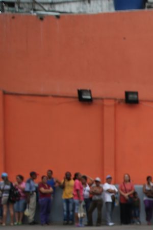 A shopper leaves a supermarket with flour and eggs after waiting for hours for scarce foodstuffs on March 2, 2014 in Caracas, Venezuela. Photo by John Moore/Getty Images