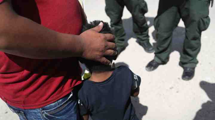 U.S. Border Patrol agents take a father and son from Honduras into custody near the U.S.-Mexico border. Photo by John Moore/Getty Images