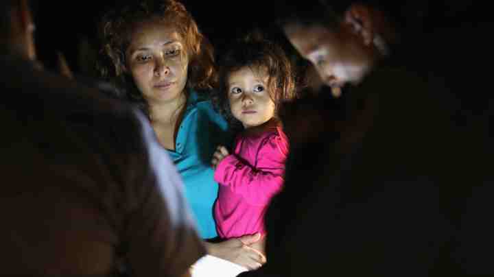 Central American asylum seekers, including a Honduran girl, 2, and her mother, are taken into custody near the U.S.-Mexico border.  Photo by John Moore/Getty Images