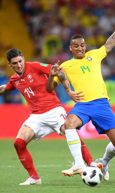 Steven Zuber of Switzerland challenge for the ball with Danilo of Brazil  during the 2018 FIFA World Cup.  Photo by Laurence Griffiths/Getty Images