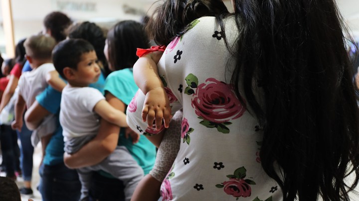 Dozens of women and their children, many fleeing poverty and violence in Honduras, Guatamala and El Salvador, arrive at a bus station following release from Customs and Border Protection in McAllen, Texas. Photo by Spencer Platt/Getty Images