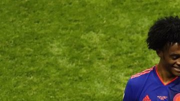 Yerry Mina of Colombia celebrates with teammate Juan Cuadrado after scoring his team's first goal during the 2018 FIFA World Cup. (Photo by Julian Finney/Getty Images)