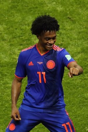 Yerry Mina of Colombia celebrates with teammate Juan Cuadrado after scoring his team's first goal during the 2018 FIFA World Cup. (Photo by Julian Finney/Getty Images)