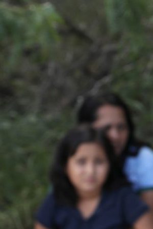 Central American asylum seekers wait as U.S. Border Patrol agents take them into custody on June 12, 2018. Photo by John Moore/Getty Images