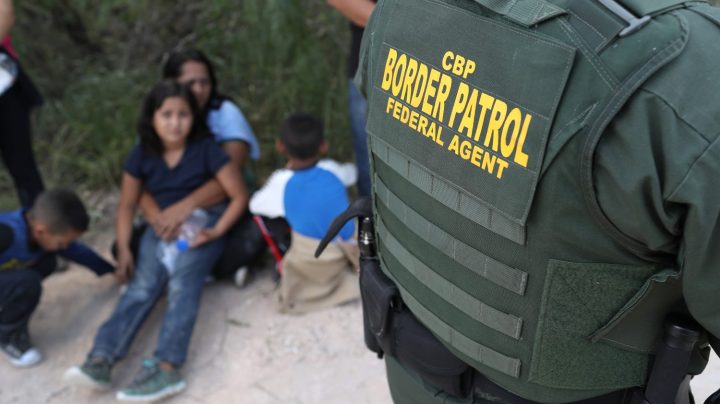 Central American asylum seekers wait as U.S. Border Patrol agents take them into custody on June 12, 2018. Photo by John Moore/Getty Images
