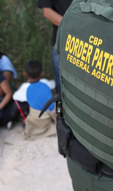 Central American asylum seekers wait as U.S. Border Patrol agents take them into custody on June 12, 2018. Photo by John Moore/Getty Images