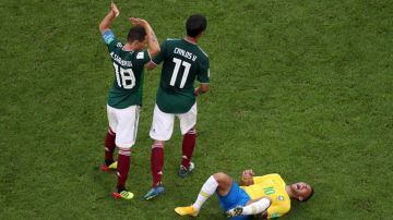 Neymar Jr of Brazil lies on the pitch injured during 2018 World Cup match with Mexico.  (Photo by Clive Rose/Getty Images)