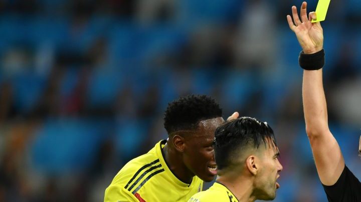 Radamel Falcao of Colombia is shown a yellow card by referee Mark Geiger during the 2018 FIFA World Cup. (Photo by Dan Mullan/Getty Images)