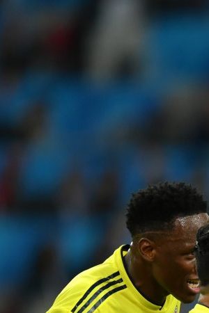 Radamel Falcao of Colombia is shown a yellow card by referee Mark Geiger during the 2018 FIFA World Cup. (Photo by Dan Mullan/Getty Images)