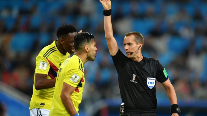 Radamel Falcao of Colombia is shown a yellow card by referee Mark Geiger during the 2018 FIFA World Cup. (Photo by Dan Mullan/Getty Images)