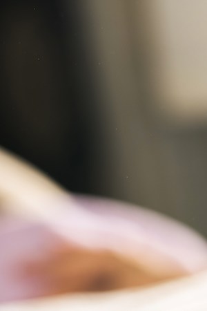 Close up of unrecognizable beautician applying clay mask on woman's face during beauty treatment. Photo by StockPlanets/ Getty Images