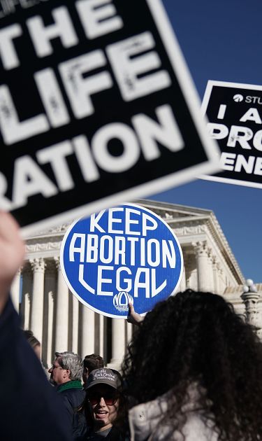 Pro-life activists try to block the sign of a pro-choice activist during the 2018 March for Life January 19, 2018 in Washington, DC. Photo by Alex Wong/Getty Images