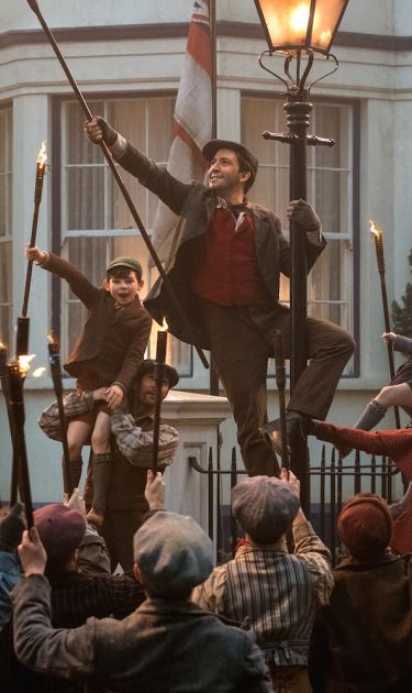 Jack (Lin-Manuel Miranda) Mary Poppins (Emily Blunt) and the Banks children with a crew of street lamplighters at 17 Cherry Tree Lane in 'Mary Poppins Returns.' Courtesy of Disney