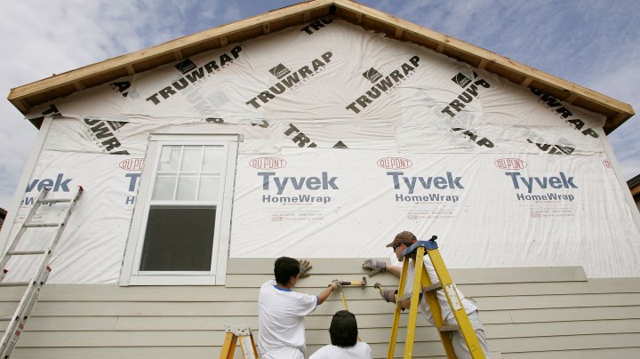 Volunteer construction workers with Habitat for Humanity work on a new home August 23, 2006 in Upper Ninth Ward of New Orleans, Louisianna. Photo by Justin Sullivan/Getty Images
