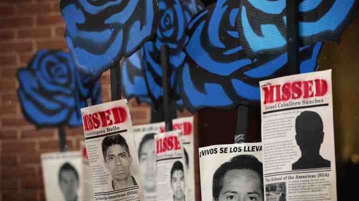 Activists hold signs during a rally to protest the Mexican governments handling of the Ayotzinapa 43 incidence outside the Inter-American Commission of Human Rights as the commission is to hear testimonies on General Human Rights Situation in the State of Guerrero, Mexico March 20, 2015 in Washington, DC. Photo by Alex Wong/Getty Images