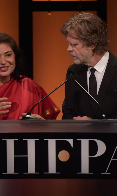 President of HFPA Meher Tatna and William H. Macy onstage during the Hollywood Foreign Press Association's Grants Banquet at The Beverly Hilton Hotel on August 9, 2018 in Beverly Hills, California. Photo by Kevin Winter/Getty Images