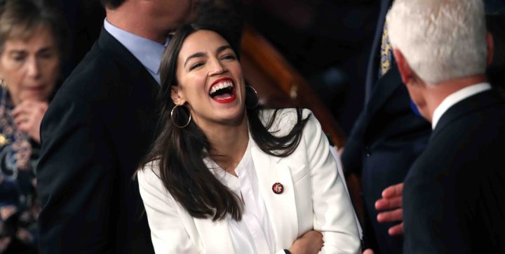 Rep. Alexandria Ocasio-Cortez (D-NY) talks to fellow members of Congress during the first session of the 116th Congress at the U.S. Capito. Photo by Win McNamee/Getty Images
