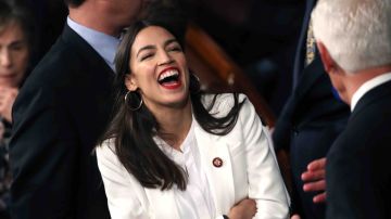 Rep. Alexandria Ocasio-Cortez (D-NY) talks to fellow members of Congress during the first session of the 116th Congress at the U.S. Capito. Photo by Win McNamee/Getty Images