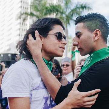 Two Pasarela de Putxs participants embrace (and later kiss) before the crowd. Photo by Mari B. Robles López for Remezcla