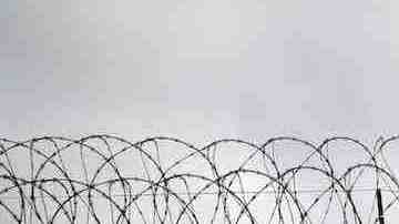Double strands of concertina wire stretch across the U.S.-Mexico border fence on October 3, 2013 near San Ysidro, California. Photo by John Moore/Getty Images