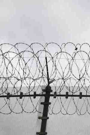 Double strands of concertina wire stretch across the U.S.-Mexico border fence on October 3, 2013 near San Ysidro, California. Photo by John Moore/Getty Images