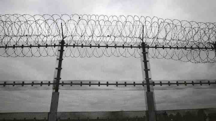 Double strands of concertina wire stretch across the U.S.-Mexico border fence on October 3, 2013 near San Ysidro, California. Photo by John Moore/Getty Images