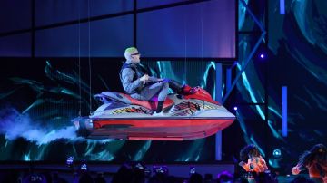 Bad Bunny rides on a personal watercraft above the stage as he performs during the 2019 Billboard Latin Music Awards at the Mandalay Bay Events Center on April 25, 2019 in Las Vegas, Nevada. Photo by Ethan Miller/Getty Images