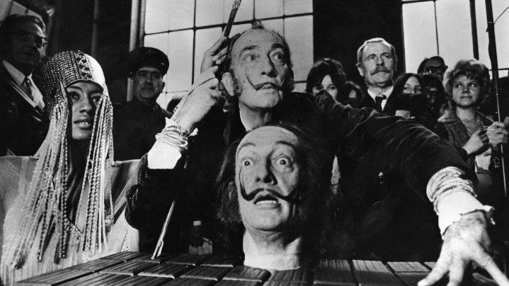 Spanish surrealist painter Salvador Dali with a model of his own head, at a press conference in Paris. Photo by Keystone/Getty Images