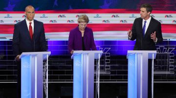 Former Texas congressman Beto O'Rourke speaks as Sen. Cory Booker and Sen. Elizabeth Warren during the first night of the Democratic presidential debate on June 26, 2019 in Miami, Florida.  Photo by Joe Raedle/Getty Images