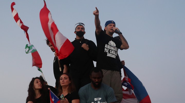 Rappers Residente and Bad Bunny join demonstrators protesting against Ricardo Rossello, the Governor of Puerto Rico July 17, 2019 in Old San Juan, Puerto Rico. Photo by Joe Raedle/Getty Images
