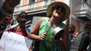 Protesters demonstrate against Ricardo Rossello, the Governor of Puerto Rico, near a police barricade set up along a street leading to the governor's mansion on July 20, 2019 in Old San Juan, Puerto Rico. Photo by Joe Raedle/Getty Images