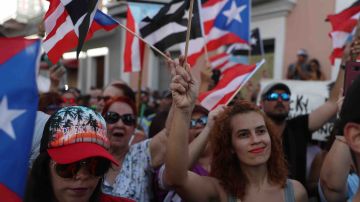 Protesters demonstrate against Ricardo Rosselló, the governor of Puerto Rico, near police that are manning a barricade set up along a street leading to the governor's mansion on July 21, 2019 in Old San Juan, Puerto Rico. Photo by Joe Raedle/Getty Images