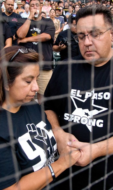 Attendees pray for the victims of the Walmart shooting at Southwest University Park, where the city of El Paso held the official vigil. Photo by Gabriela Velasquez for Remezcla