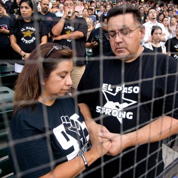 Attendees pray for the victims of the Walmart shooting at Southwest University Park, where the city of El Paso held the official vigil. Photo by Gabriela Velasquez for Remezcla