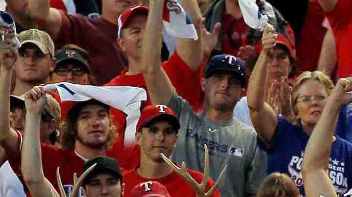 Fans cheer as Neftali Feliz #30 of the Texas Rangers pitches against the New York Yankees in Game Two of the ALCS during the 2010 MLB Playoffs at Rangers Ballpark in Arlington in 2010 in Arlington, Texas. Photo by Stephen Dunn/Getty Images