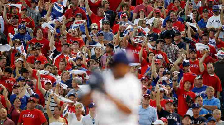 Fans cheer as Neftali Feliz #30 of the Texas Rangers pitches against the New York Yankees in Game Two of the ALCS during the 2010 MLB Playoffs at Rangers Ballpark in Arlington in 2010 in Arlington, Texas. Photo by Stephen Dunn/Getty Images